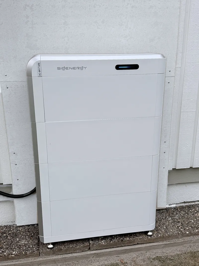 SigenStor-batteri i fyra staplade moduler utomhus vid en villafasad